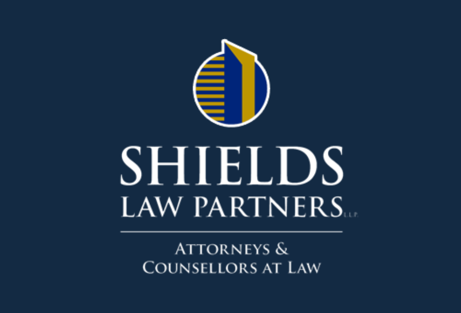 Shields Law Partners Logo - White on Blue with Yellow Accents