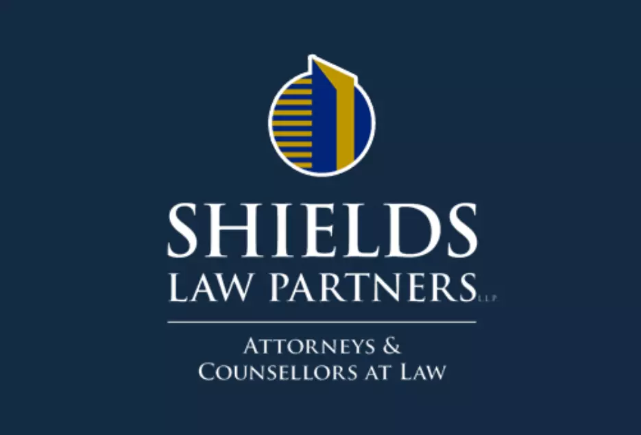 Shields Law Partners Logo - White on Blue with Yellow Accents